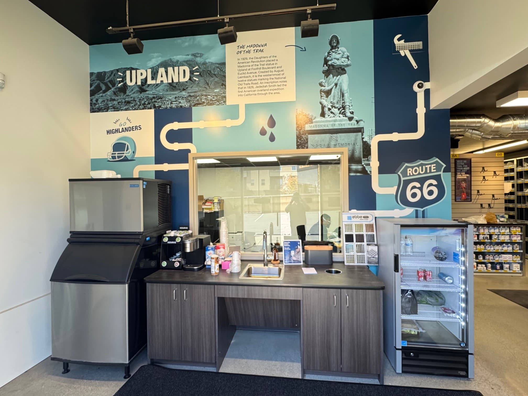 Sales floor refreshment center with service counter, cabinetry, and customer seating in a commercial trade environment.