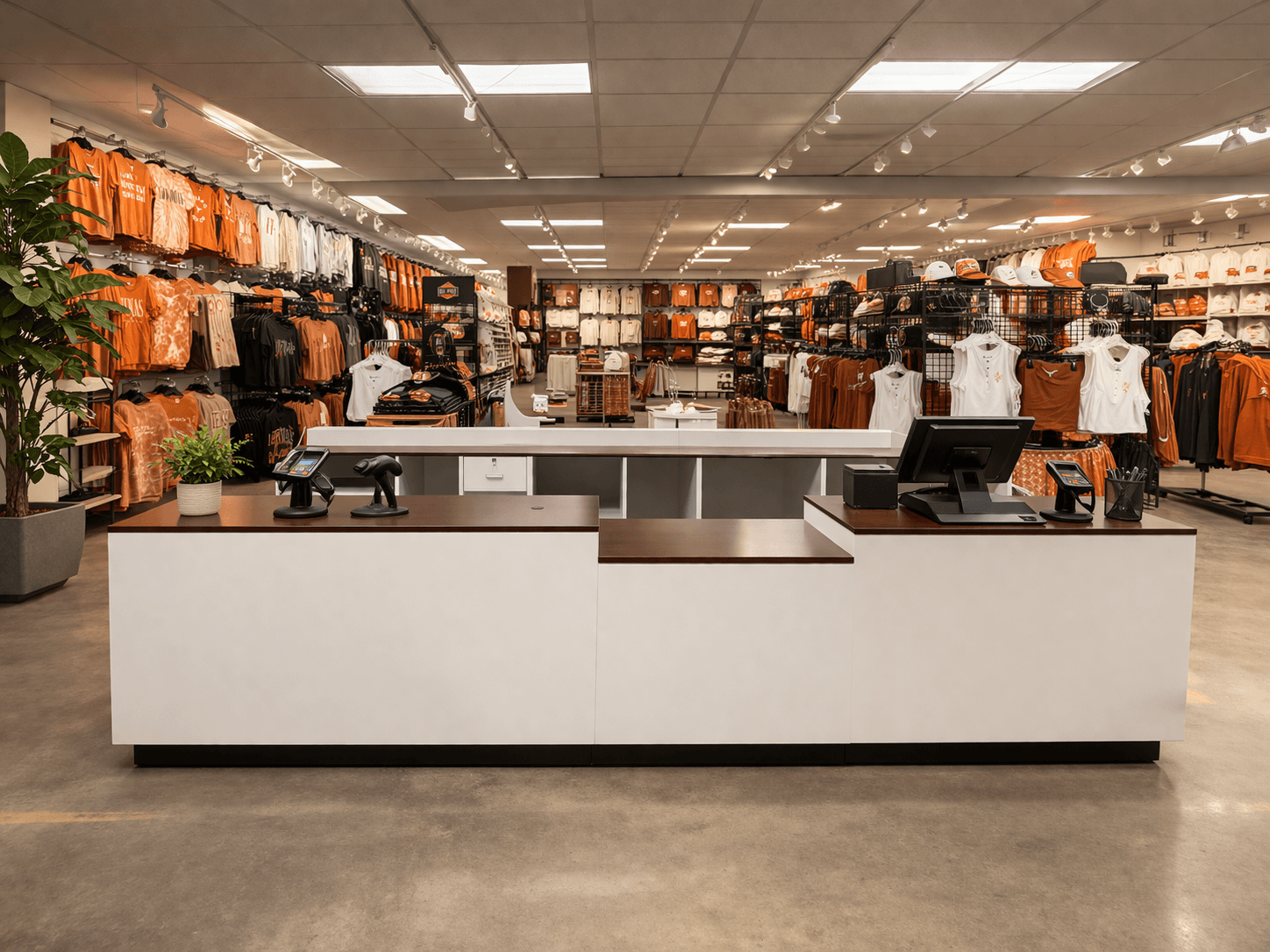 Modern retail store with a white and wood point-of-sale counter and apparel displays on the sales floor.